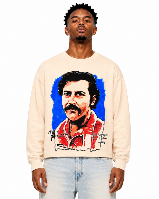 Person wearing a beige sweatshirt with a graphic of a man with a mustache on a white background