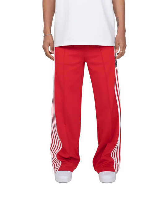 Red pants with white stripes worn by a person on a white background