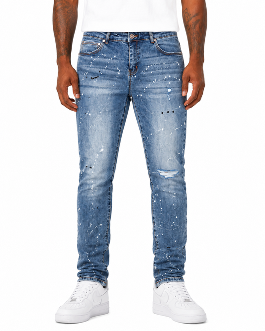 Person wearing light blue distressed jeans on a white background
