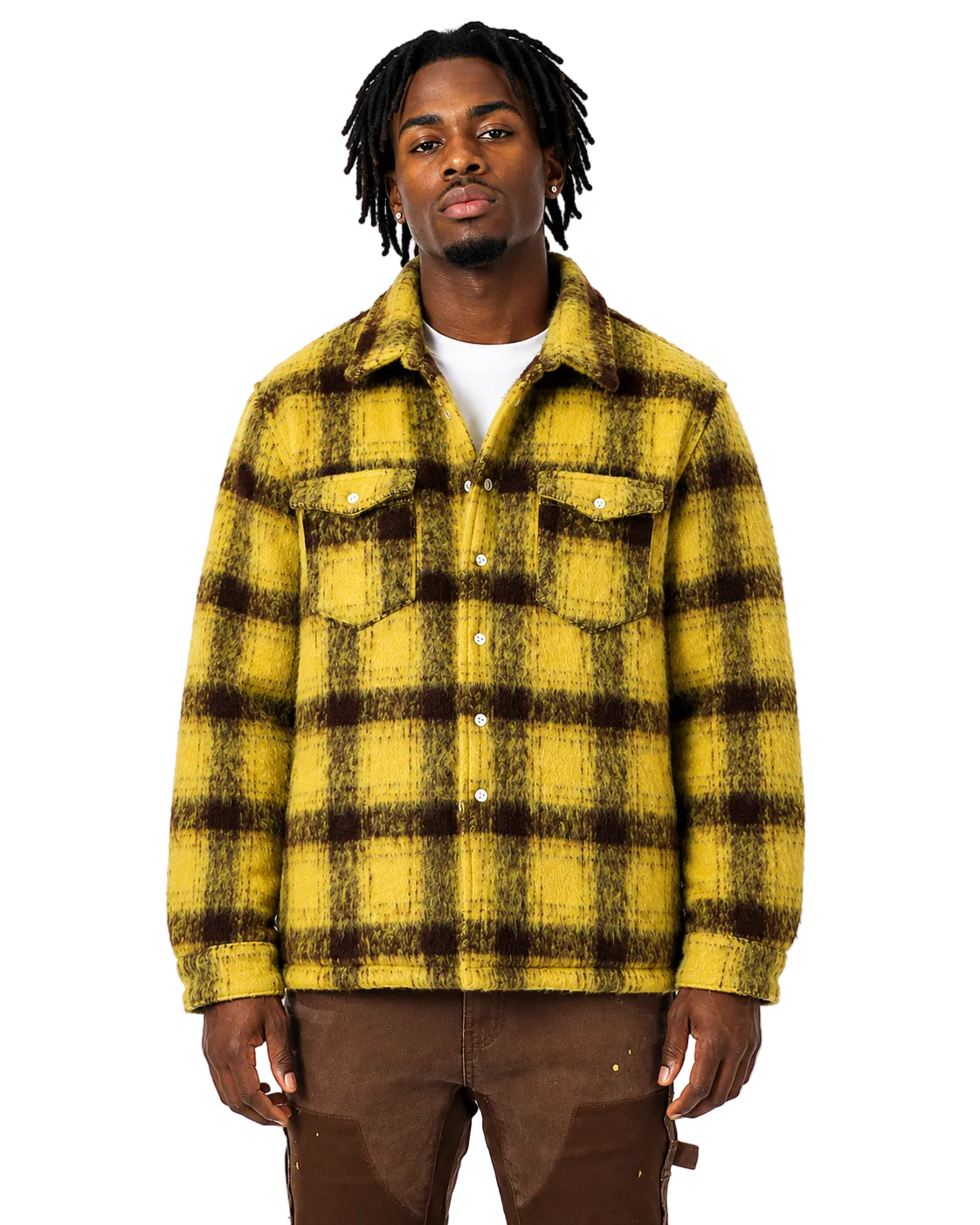 Man with dreads wearing a yellow and brown plaid shirt on a white background